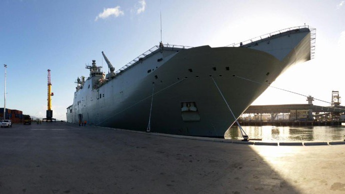 A large, modern Naval ship docked in Townsville