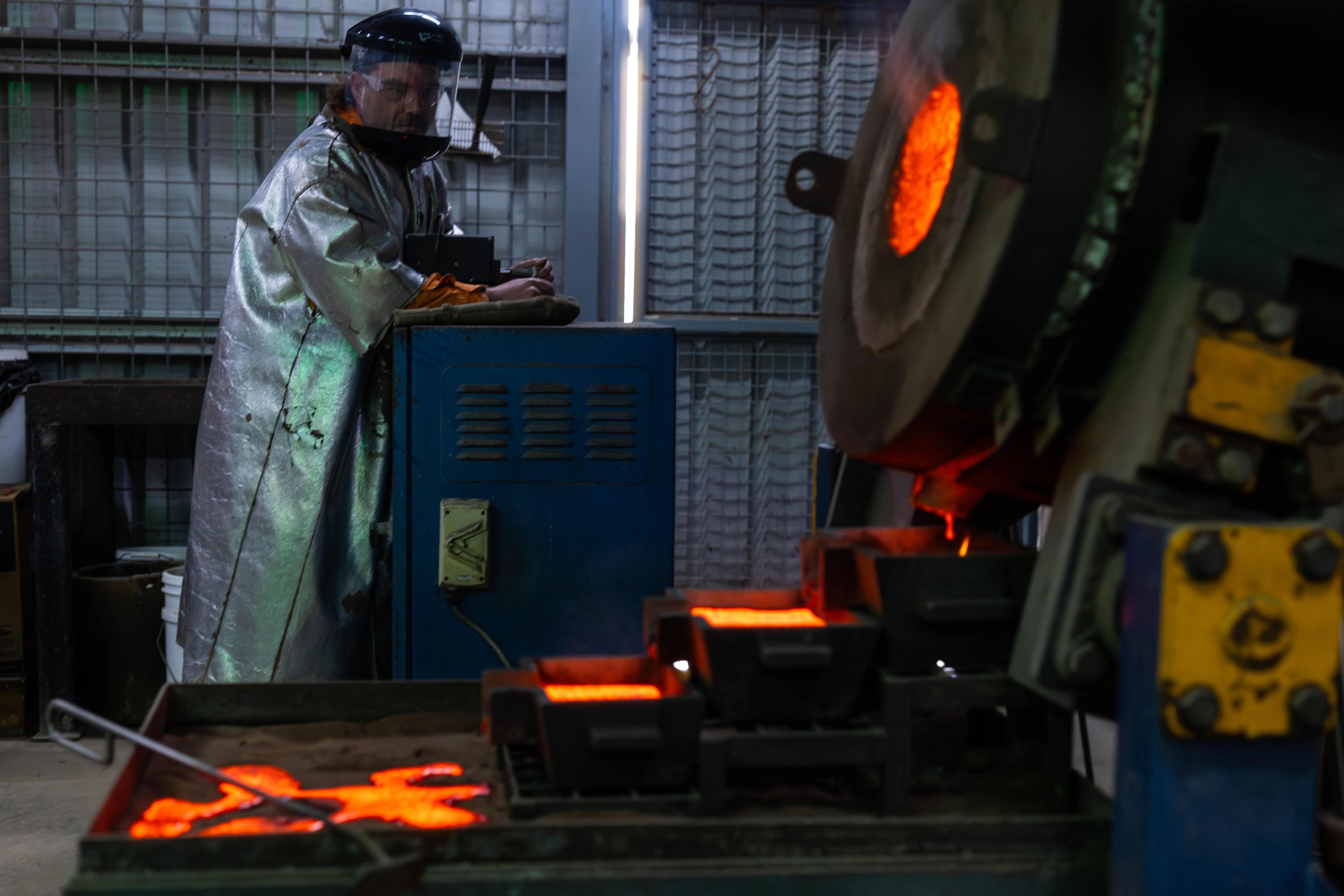 A furnace with hot metal being poured.  