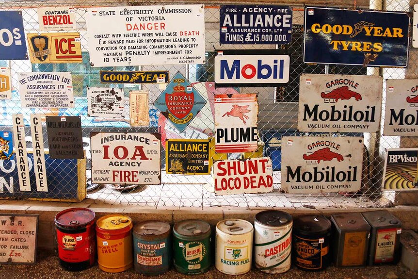A wall covered in old signs.