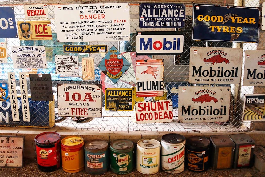 A wall covered in old signs.