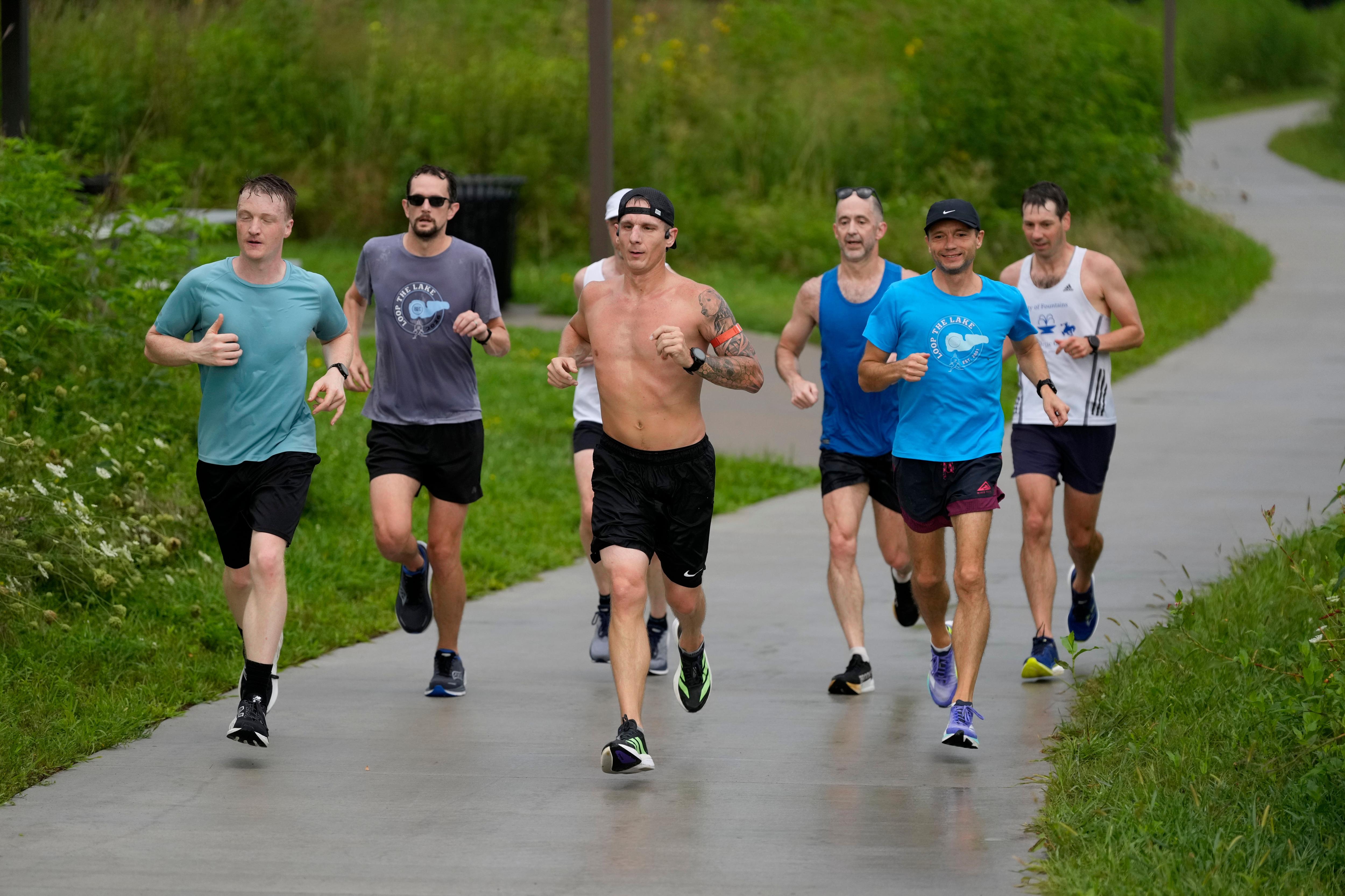 Members of a running club on a run outdoors along a path
