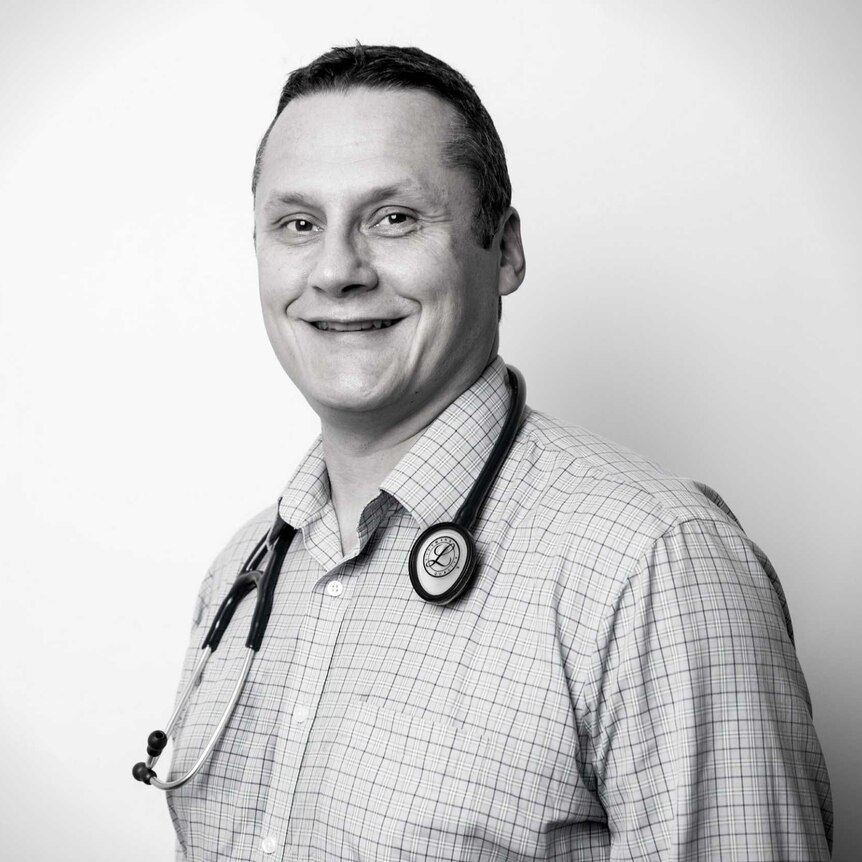 A smiling man with a stethoscope around his neck