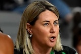The West Coast Fever Super Netball head coach speaks to her players during a break.