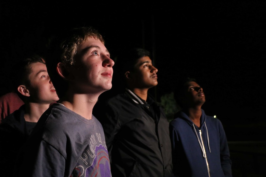 Year 8 student Harrison Tri looks at the stars with his classmates.