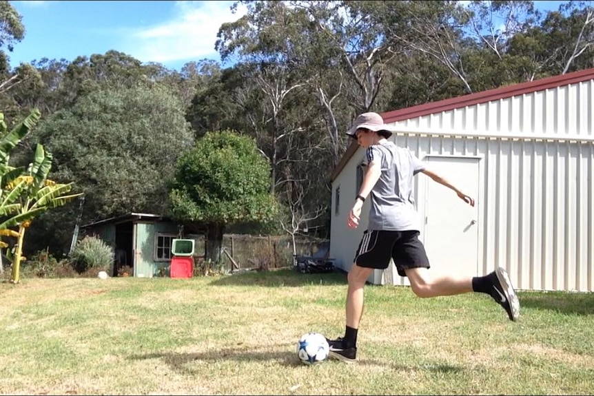 Jed Hockin goes to kick a soccer ball