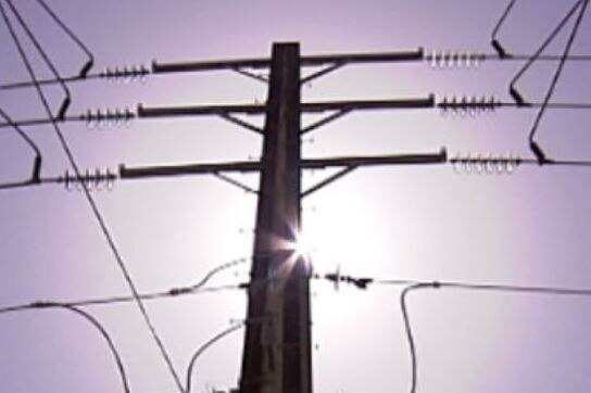 Powerlines against a sunny blue sky background