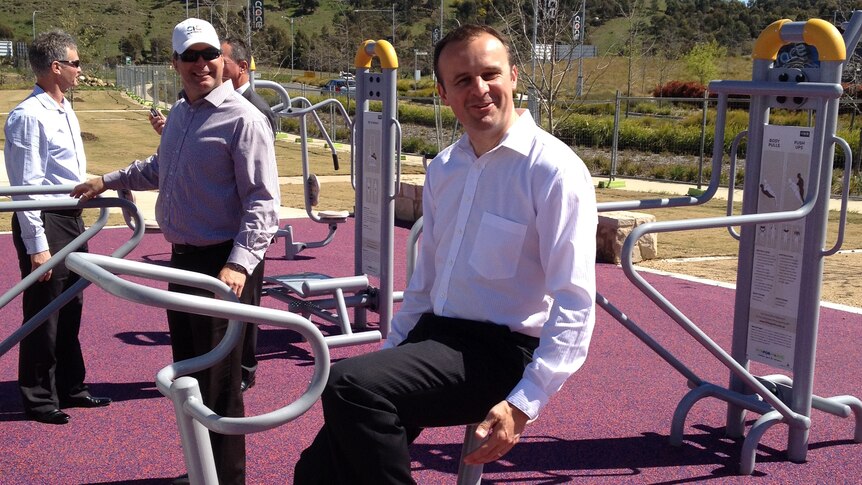 ACT Sports Minister Andrew Barr trying out the outside gym at the near completed park in Crace.