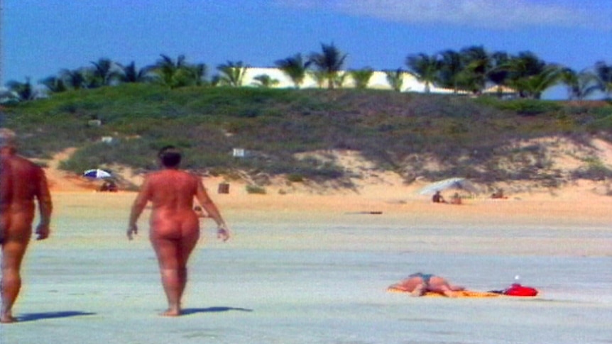 Two nudists walk on Cable Beach.