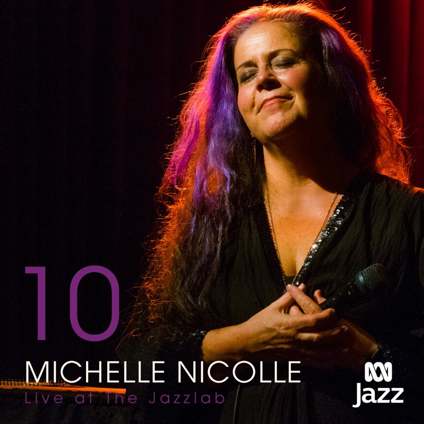 A colour photo of a smiling Michelle Nicolle on-stage at the Jazzlab in Melbourne