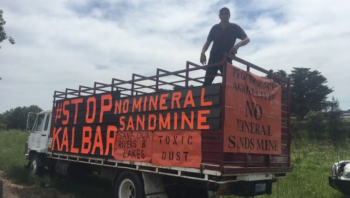 Man on truck with protest signs