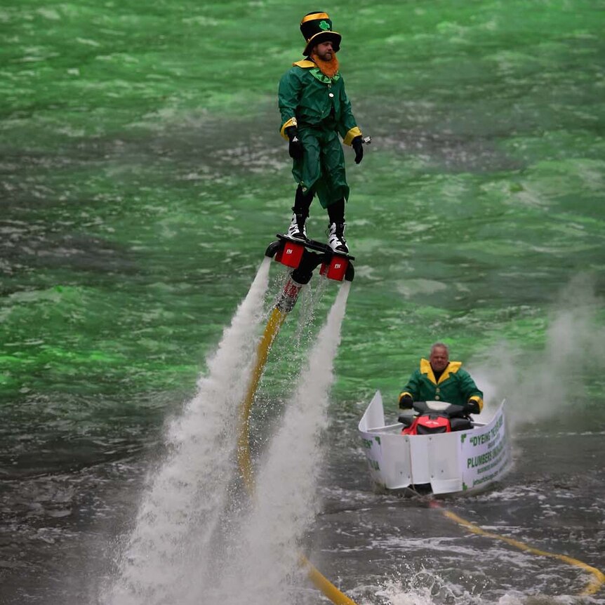Leprechaun rides a green Chicago River