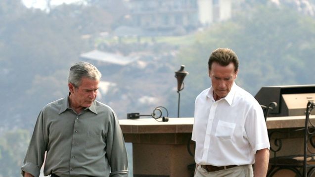 Tour of disaster area: George W Bush with California Governor Arnold Schwarzenegger