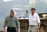 Tour of disaster area: George W Bush with California Governor Arnold Schwarzenegger