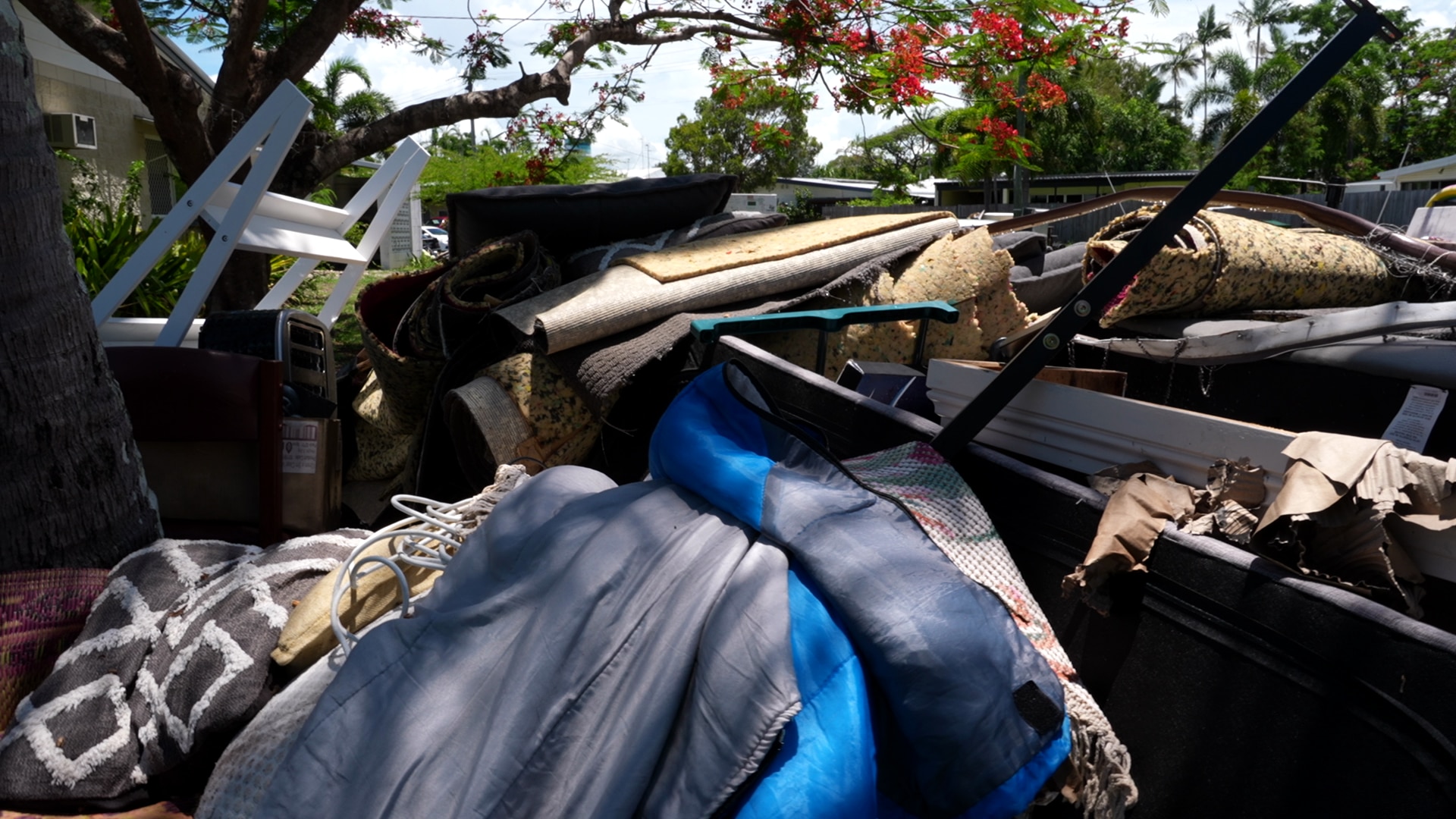 A pile of rubbish, including mattresses and flooring