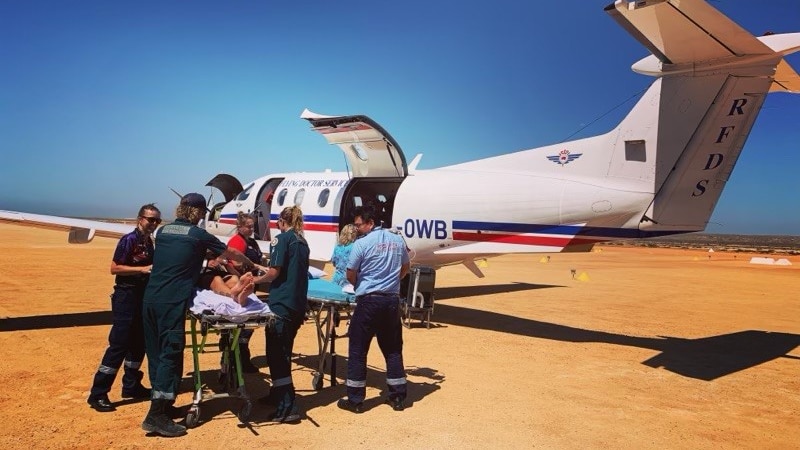 Snake bite victim Nigel Dow being loaded into an RFDS aircraft in January 2022.