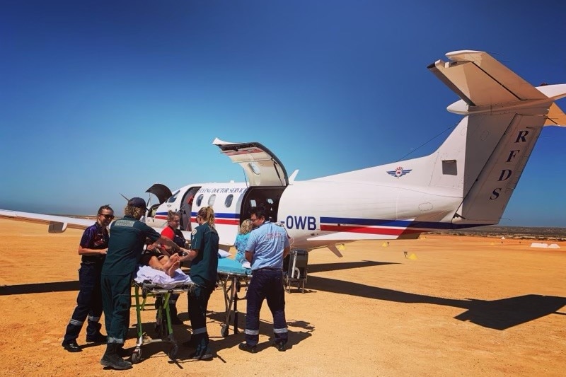 Snake bite victim Nigel Dow being loaded into an RFDS aircraft in January 2022.