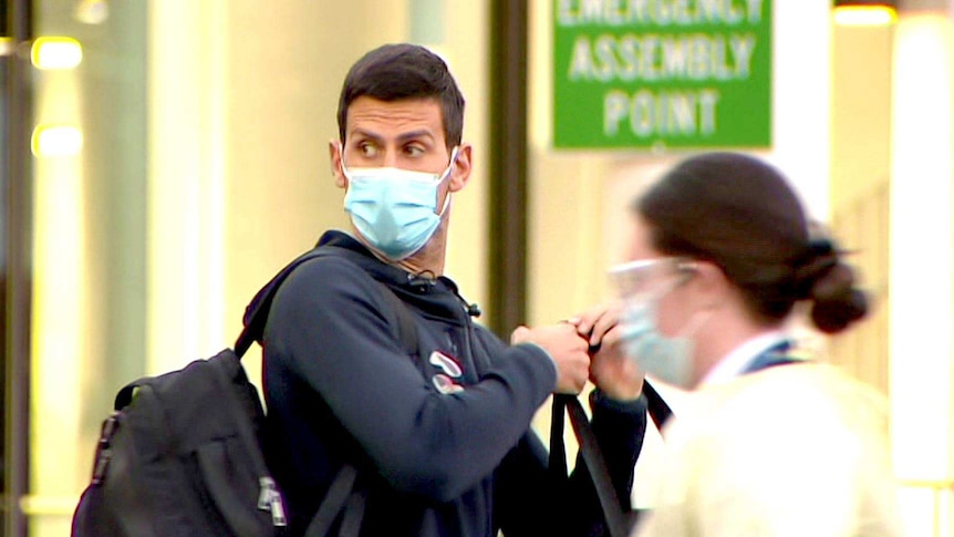 A masked Novak Djokovic at Adelaide Airport.