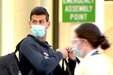 A masked Novak Djokovic at Adelaide Airport.