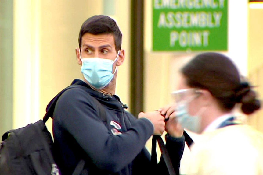 A masked Novak Djokovic at Adelaide Airport.