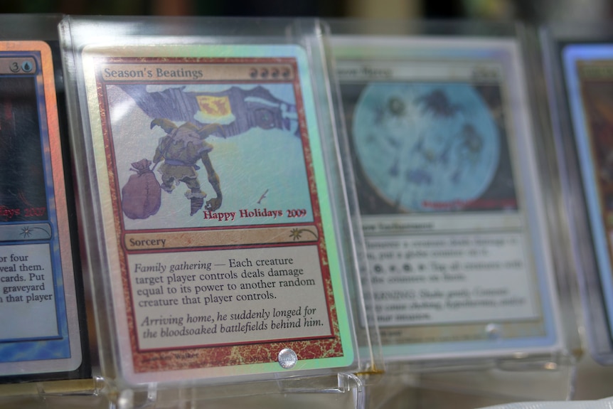 A close up of some shiny cards with a magical beast on it 