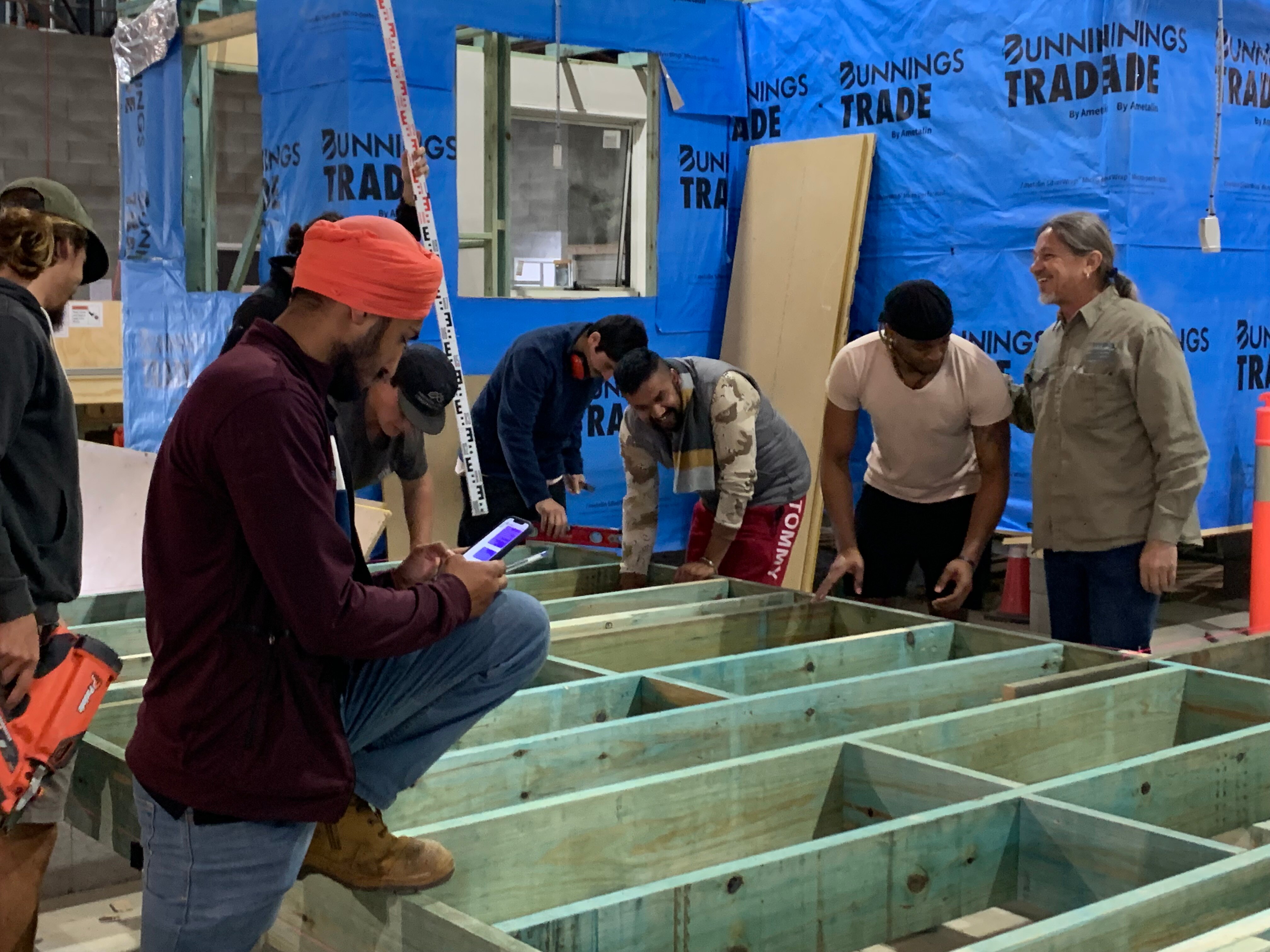 Group of students working on timber building frame