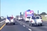 A screengrab from a video on social media showing Trump supporters' vehicles surrounding a Biden campaign bus on a highway.