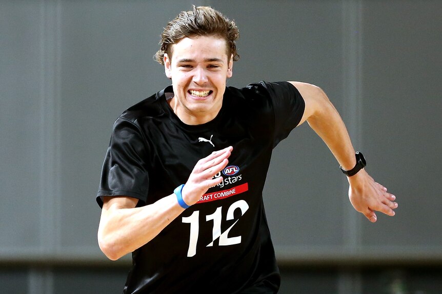 A teenager Australian rules footballer runs at the AFL Draft National Combine.