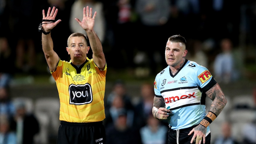 Josh Dugan runs next to referee Ben Cummins, who is holding both hands up above his head with his fingers outstretched