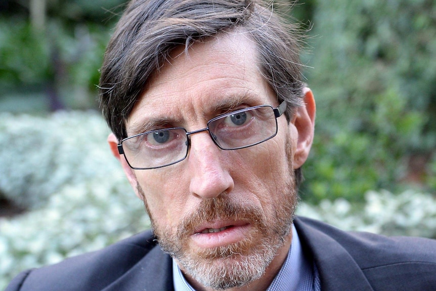 Abuse survivor John Ellis outside NSW Parliament.