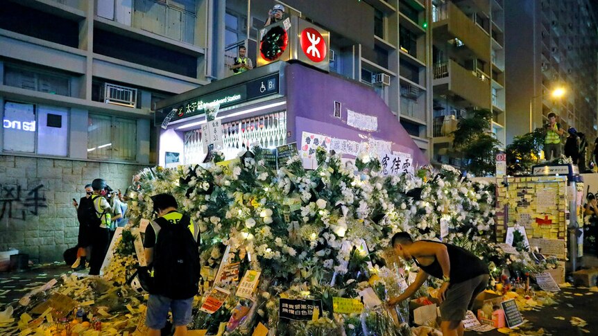 An image of Hong Kong's Prince Edward metro station shuttered and blanketed with white flowers around its perimeter.