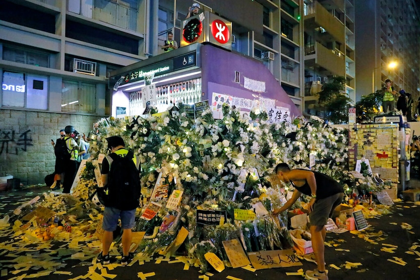 An image of Hong Kong's Prince Edward metro station shuttered and blanketed with white flowers around its perimeter.