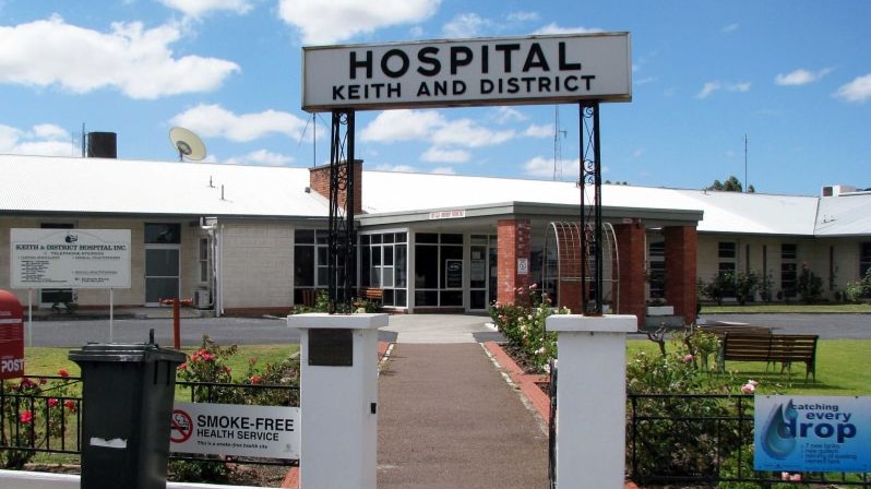 An arched sign reading 'Hospital Keith and District' outside a brick hospital building.