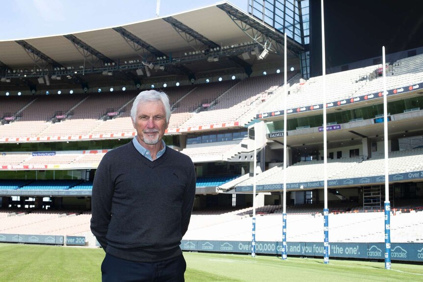Former AFL coach Mick Malthouse stands on the field at the MCG.