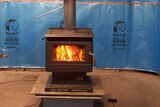 Photograph of a wood heater being tested for efficiency.