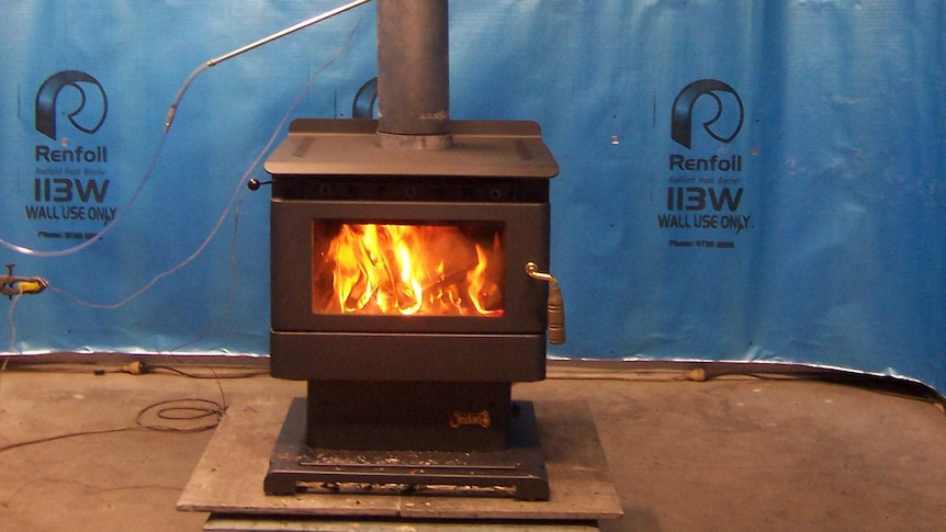 Photograph of a wood heater being tested for efficiency.