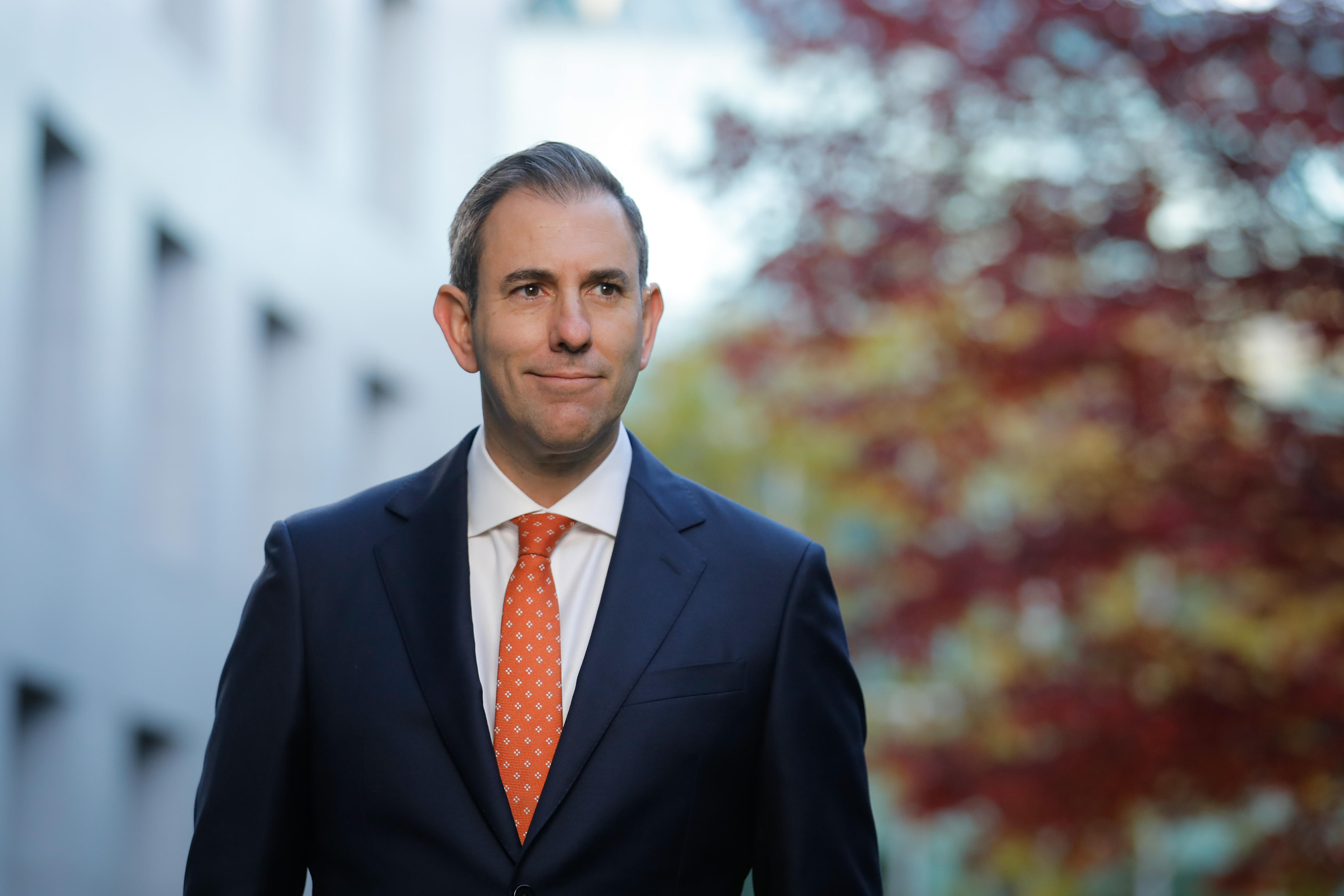 Jim Chalmers stands in a courtyard at parliament house. 