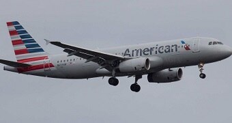 An American Airlines plane is flying in the air.