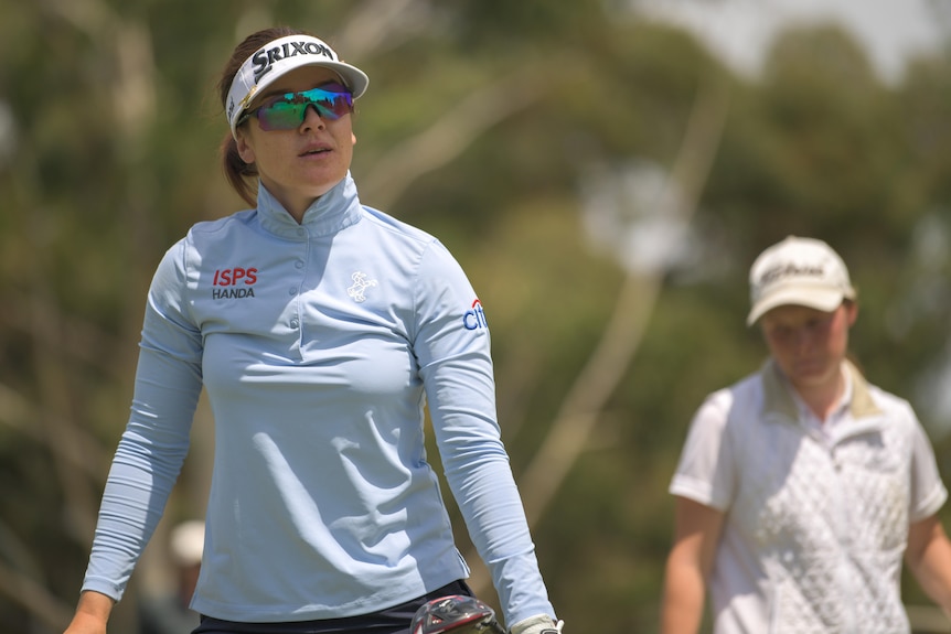 A female professional golfer watches a stroke suring the TPS Murray River tournament.