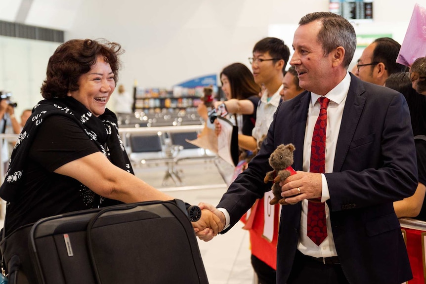 WA Premier Mark McGowan greets Chinese tourists at Perth Airport.