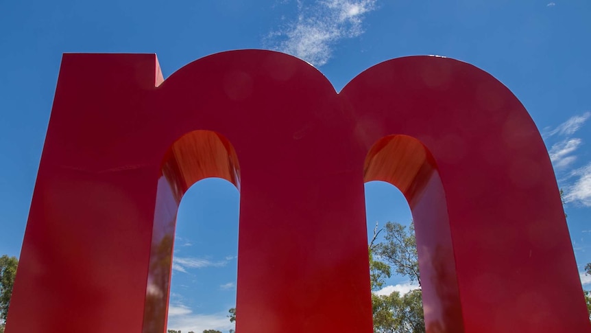 A huge red letter m in a paddock