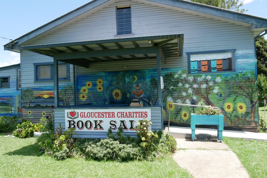 Bright mural painted on the front of a blue bookshop.