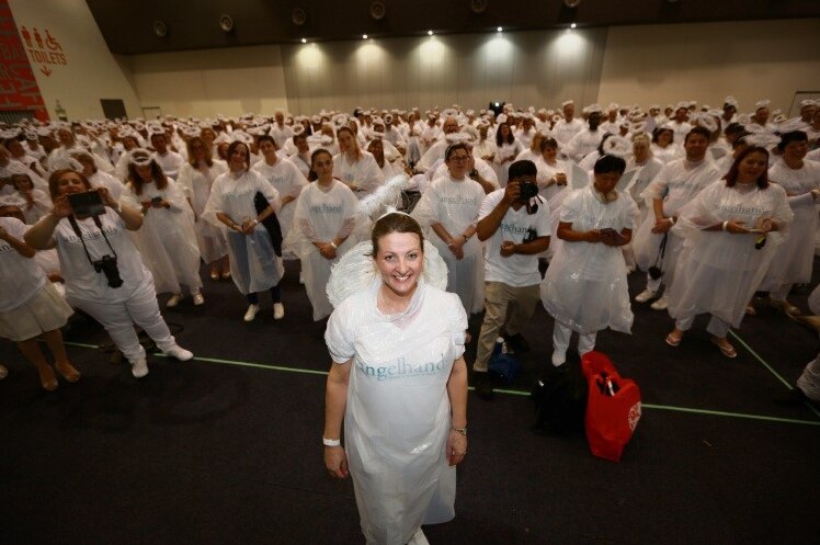 Dr O'Neill dressed as an angel, and surrounded by angels, at the 2018 attempt to break the world record.
