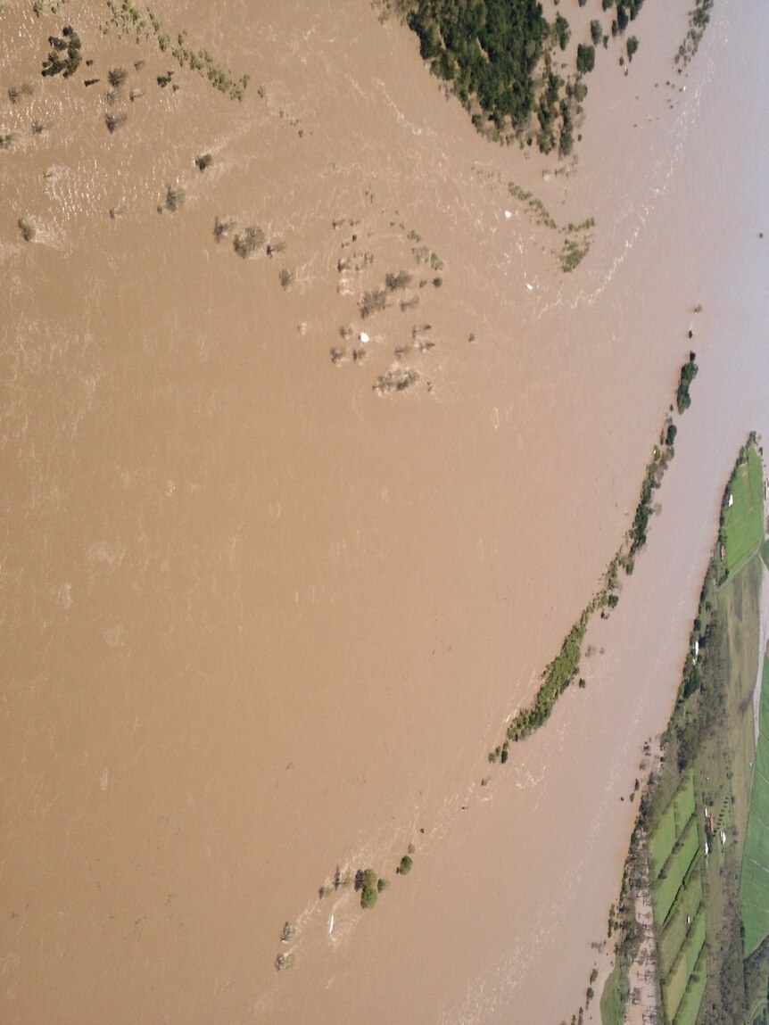 A flooded Burnett River runs out to sea at Bundaberg