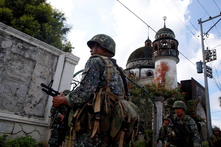 Philippine Marines stand guard outside a mosque in Marawi City.