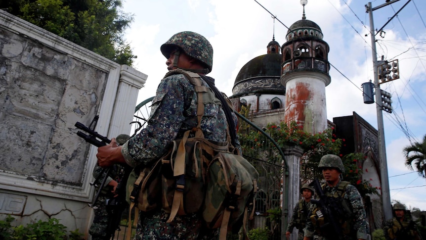 Philippine Marines stand guard outside a mosque in Marawi City.