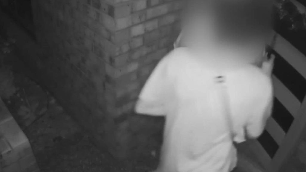 A CCTV snippet that shows two teens entering a home, their faces are blurred.