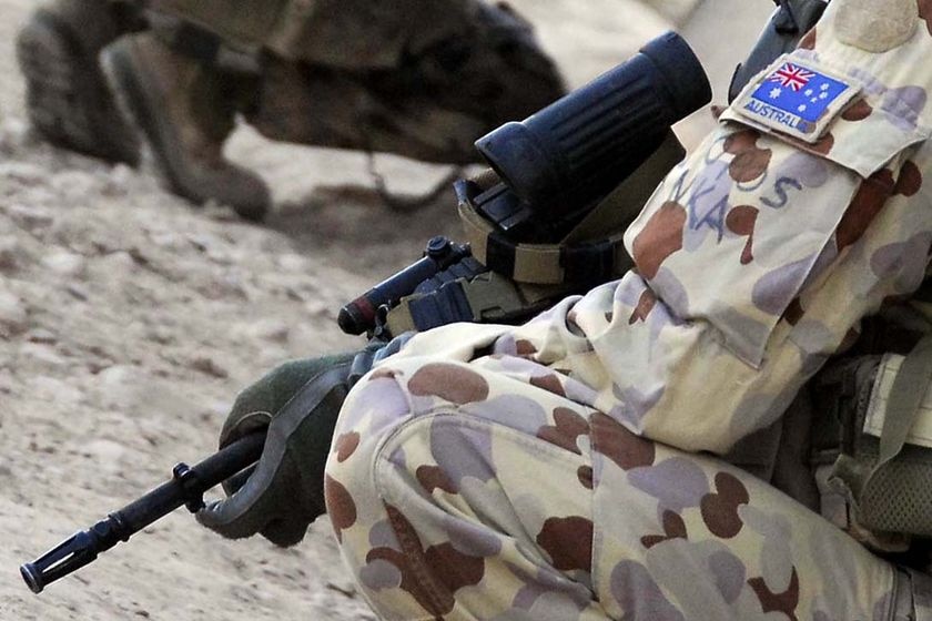 File photo: An Australian soldier patrols near Tarin Kowt in southern Afghanistan in November 2006.(Department of Defence)