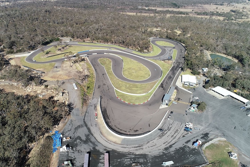 An aerial view of the Pheasant Wood track taken from a drone while some cars race on the track.
