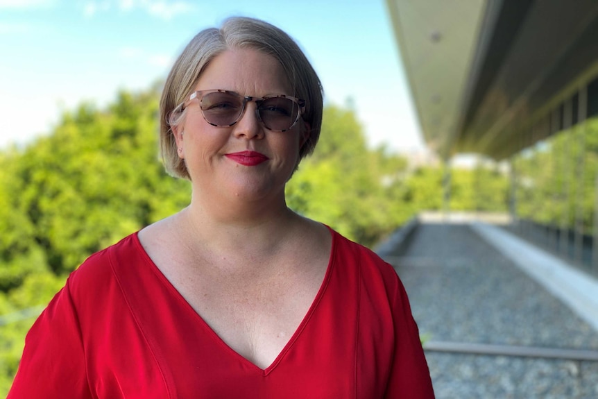 Woman in red dress and glasses