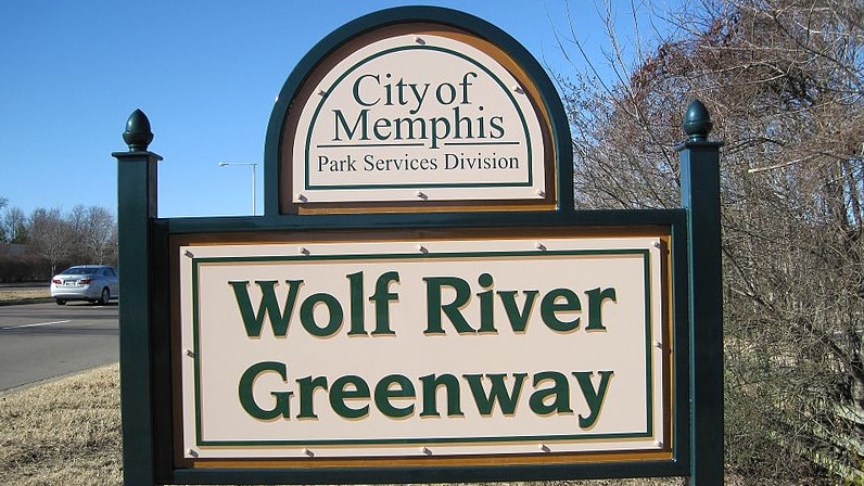 A sign that reads "Wolf River Greenway" in the city of Memphis, Tennessee, in the United States.